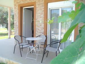 a patio with chairs and a table on a balcony at Bright Sea - Studios in Limenas +40 photos