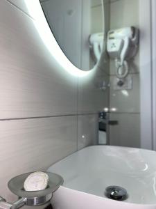 a bathroom with a white sink and a mirror at Villa Tabaku in Berat +59 photos