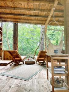 a room with two chairs and a hammock at Каравана Безвремие in Chernomorets +22 photos