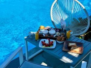 a tray of food on a table next to the water at Charakas Horizon in Gavrio