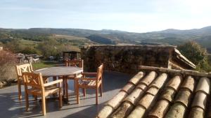 a table and chairs on a patio with a view at La vie en Rosans - The upperhouse in Saint-André-de-Rosans