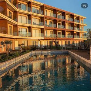 a building with a swimming pool in front of a building at Casa Montenegro Royal Sun Tivat Airport 5 Min in Tivat