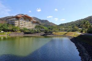 a building with a bridge over a body of water at Sunset Room at Pico - Hamilo Coast Pico De Loro in Nasugbu