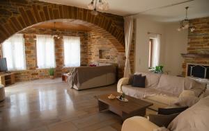 a large living room with a brick wall at The Stone Project in Ermoupoli