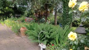 a garden with yellow flowers and a basket of plants at L' écrin de Pradou Glas in Le Saint +9 photos