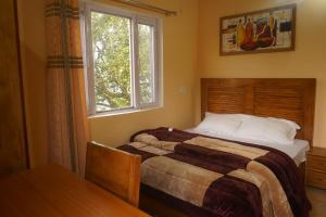 Кровать или кровати в номере Neha Homestay