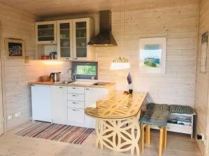 a kitchen with a wooden table and a sink at Romantic beach cottage in Kalana