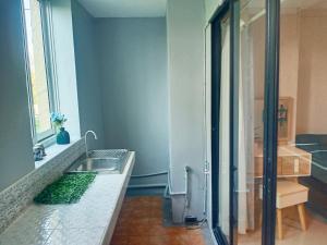 a bathroom with a sink and a glass shower at Morning cozy, airport 5-30 min in Pak Kret