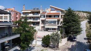 an apartment building with trees in front of a street at Thea in Kavala