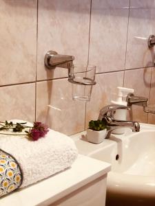 a bathroom with a sink and a faucet at Lulu Cottage in Žabljak +39 photos