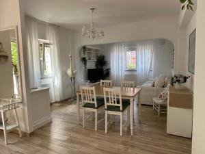 a kitchen and living room with a table and chairs at Albicocca in Falconara Marittima