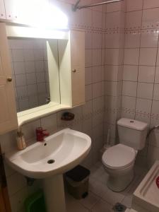 a bathroom with a sink and a toilet and a mirror at Thomas Vrasna Close To The Sea in Nea Vrasna +8 photos