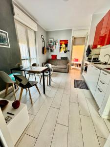 a kitchen and a living room with a table at Rooftop big Terrace fiera MIlano/Portello in Milan
