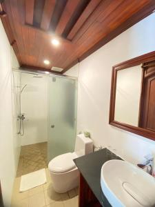 a bathroom with a shower and a toilet and a sink at Luang Prabang Villa Sirikili River View in Luang Prabang +64 photos