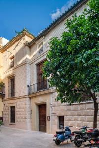 two motorcycles parked in front of a building at Gandesa, Palace House in Seville