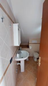 a bathroom with a sink and a toilet at Il Nido Del Viaggiatore in Vallebona +35 photos