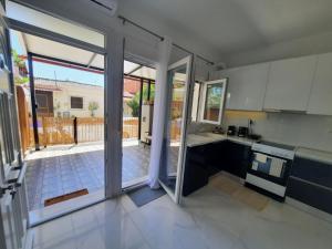 a kitchen with an open door to a patio at House B Diavata, Thessaloniki in Thessaloniki