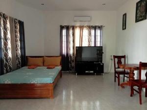 a living room with a couch and a flat screen tv at Michael's Apartment 2 in Moalboal