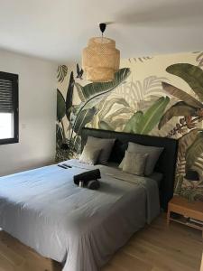 a bedroom with a large bed with blue sheets and plants at Villa avec piscine chauffée in Ancy +15 photos