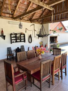 a dining room with a wooden table and chairs at Anamarija Apartments in Ličko Petrovo Selo