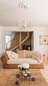 a living room with a couch and a chandelier at Villa Bella Elana in Jūrmala