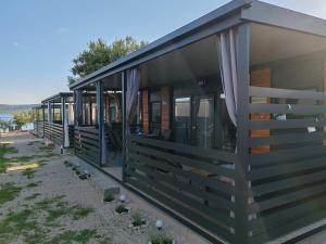 a house with windows on the side of it at EMMI Mobile Home in Sveti Petar