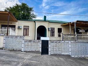 a house with a stone fence in front of it at Hostel Kutaisi by Kote in Kutaisi