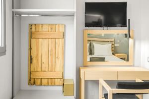 a bedroom with a bed and a wooden door at Sergiani Garden Hotel Apartments in Stalís