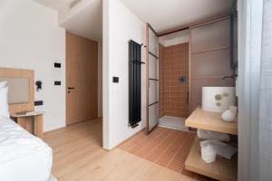 a bedroom with a shower and a bed at Hotel Al Maso in Riva del Garda