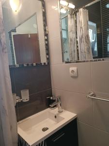 a bathroom with a sink and a mirror at Old port in Baška Voda