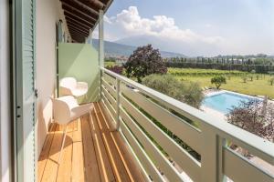 a balcony with a view of a pool and mountains at Hotel Al Maso in Riva del Garda