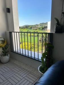 a balcony with a view of a field of flowers at Hortensia rooms in St Paul's Bay +10 photos