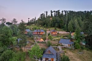 an aerial view of a house on a hill at WoodVista Cottages By Jomotel in Shimla