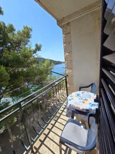 a table and chairs on a balcony with a view at Villa Kralj Mljet in Saplunara