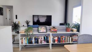 a living room with a book shelf filled with books at Valdoviño Experience in Valdoviño