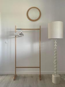 a lamp and a mirror on a wall next to a table at Blisko me in Wieprz