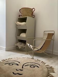 a room with a rug and a chair and a smiley face drawn on it at Blisko me in Wieprz +1 photo