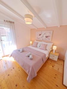 Postel nebo postele na pokoji v ubytování Apartments Nicole