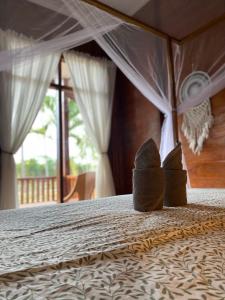 Postel nebo postele na pokoji v ubytování Nuna Bungalows