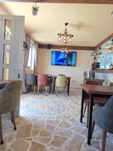 a dining room with a table and chairs at Gazdinstvo Popovic,Kucka Korita-Podgorica in Podgorica