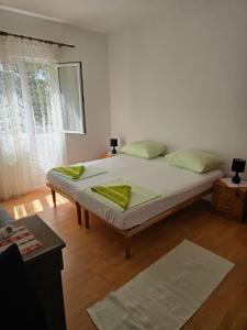 a bedroom with a large bed with yellow pillows at Villa Kralj Mljet in Saplunara