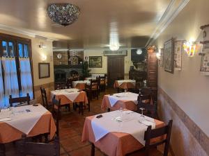 a restaurant with tables and chairs in a room at Hospederia Sagasta in Torrecilla en Cameros