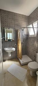 a bathroom with a toilet and a sink at Rooftop Apartment in Monastir +6 photos