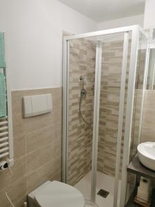 a bathroom with a shower and a toilet and a sink at VERDEACQUA Flat in Rapallo