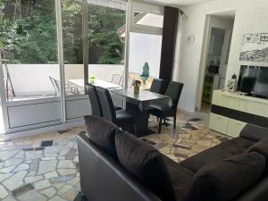 a living room with a couch and a table with chairs at Haus Karin in Lovran +20 photos