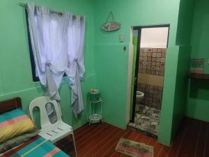 a bedroom with a bed and a bathroom with a shower at Sevene Transient Inn in Puerto Princesa City