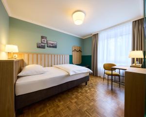 Łóżko lub łóżka w pokoju w obiekcie Hotel Limmathof