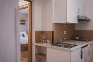 a kitchen with a sink and a counter top at Residence Chiavi D'Oro - Goldener Schl&uuml;ssel in Bressanone