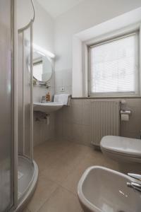 a bathroom with a sink and a toilet and a mirror at Residence Chiavi D'Oro - Goldener Schlüssel in Bressanone +29 photos