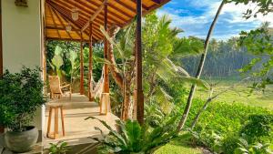 a porch of a house with a view of the mountains at The Jungle Loft Galle in Galle